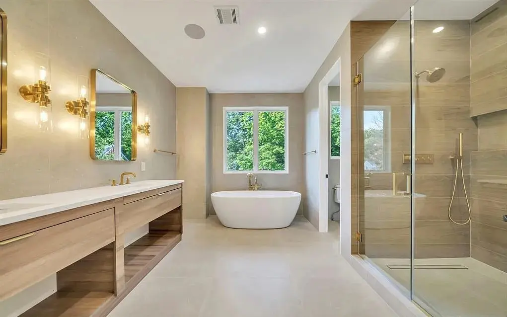 Modern bathroom renovation with freestanding tub, glass shower, and stylish fixtures